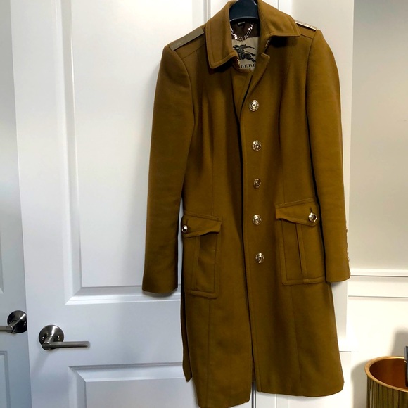 Burberry camal coat with gold buttons and Burberry name plate on shoulders.